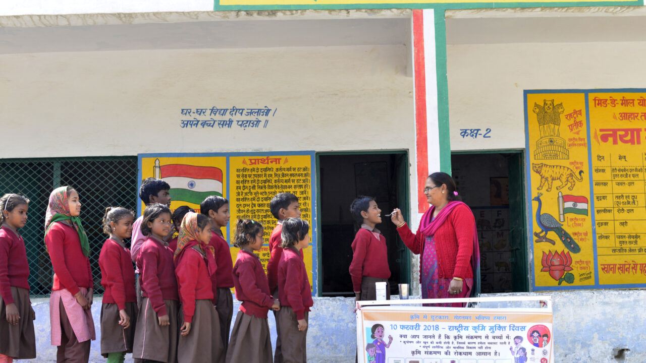 India Uttar Pradesh Children line up in a school to get their dose of Albendazole on National Deworming Day