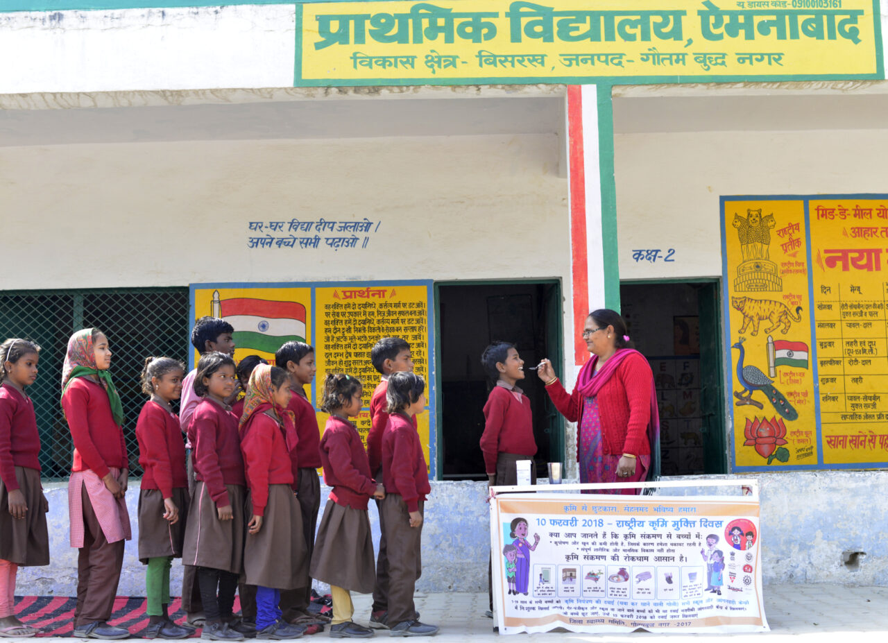 India Uttar Pradesh Children line up in a school to get their dose of Albendazole on National Deworming Day